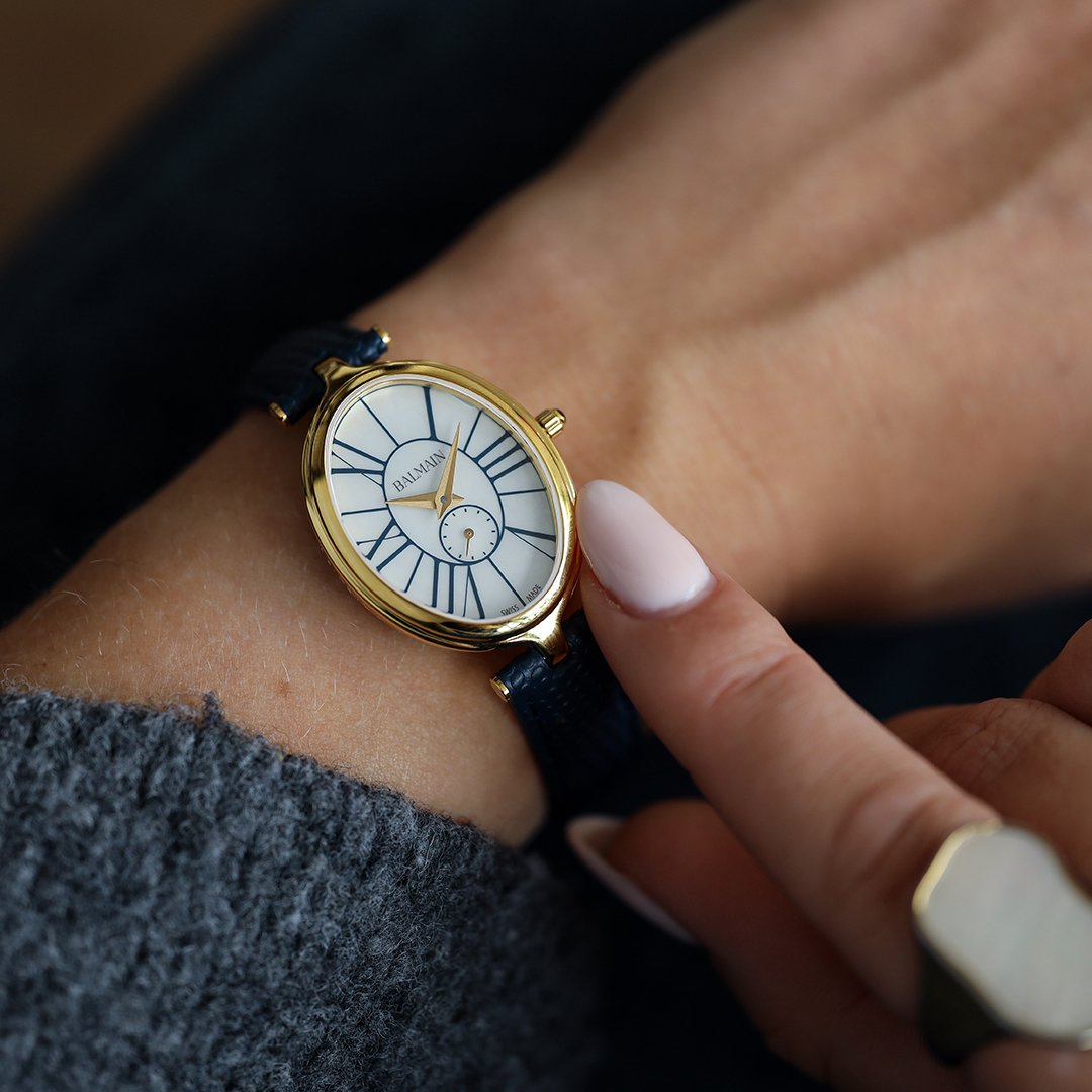 Wrist shot of a woman wearing a balmain watch