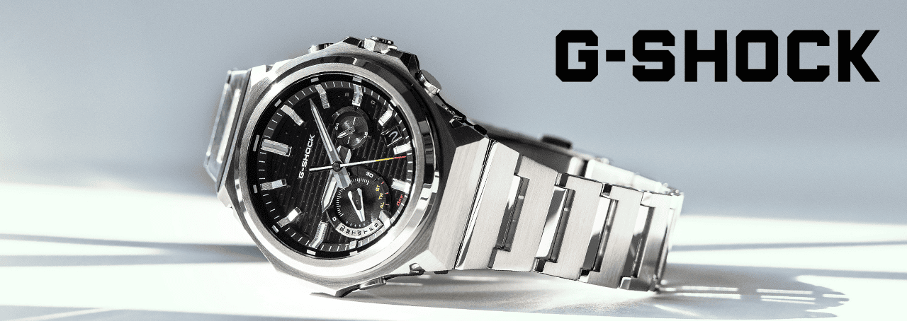 Metal G-Shock watch on a cold-toned white and grey background with a black G-Shock logo