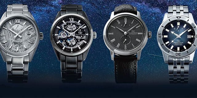 four orient watches on a blue background