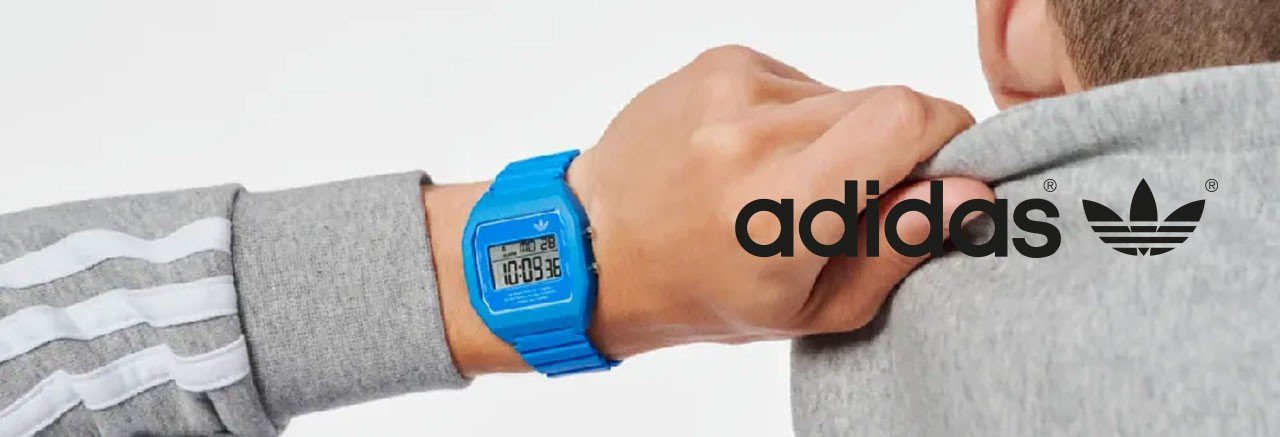 Man wearing a grey adidas train jacket and a blue digital adidas watch