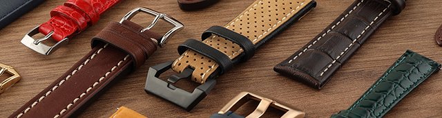 Straps on a wooden table with a little bit of pine green