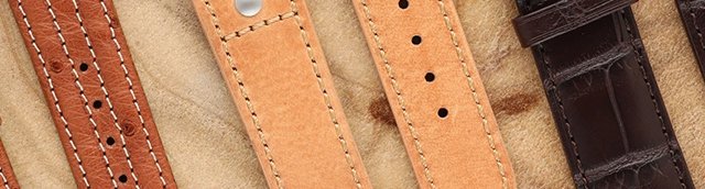 3 watch bands on wood