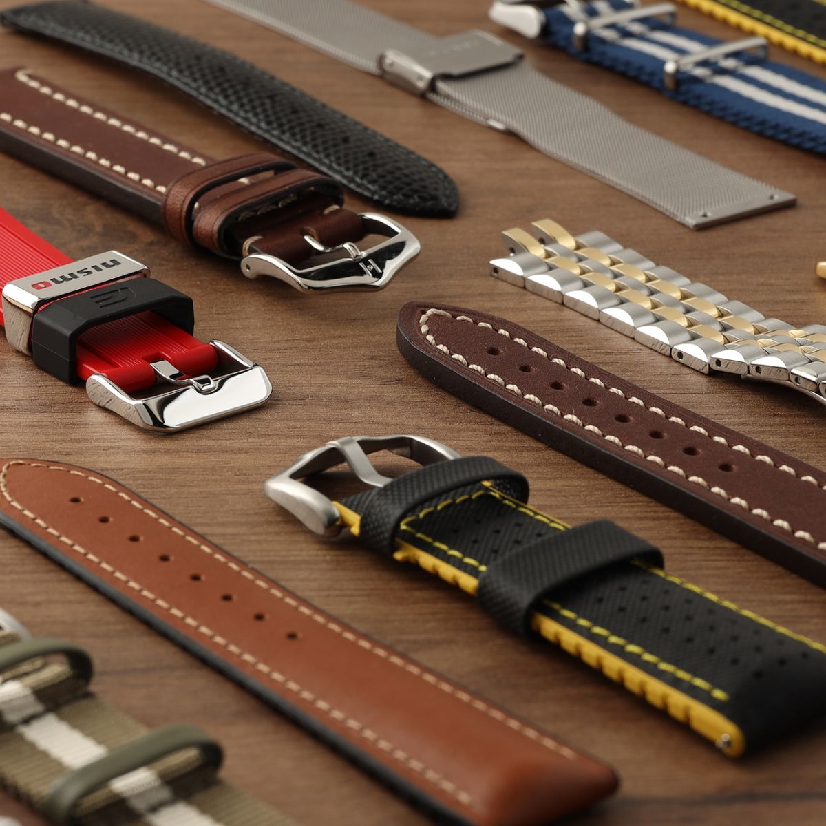 A collection of watch bands on a wooden table