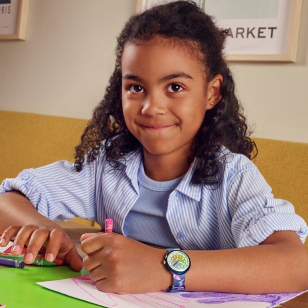 Little girl drawing with crayons