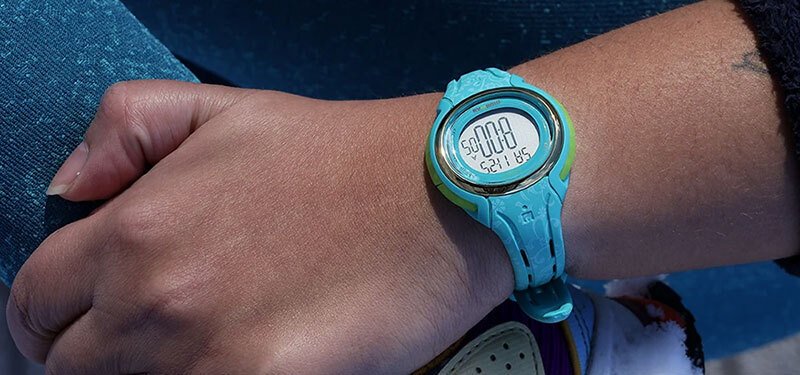 woman's wrist with a blue timex sports watch