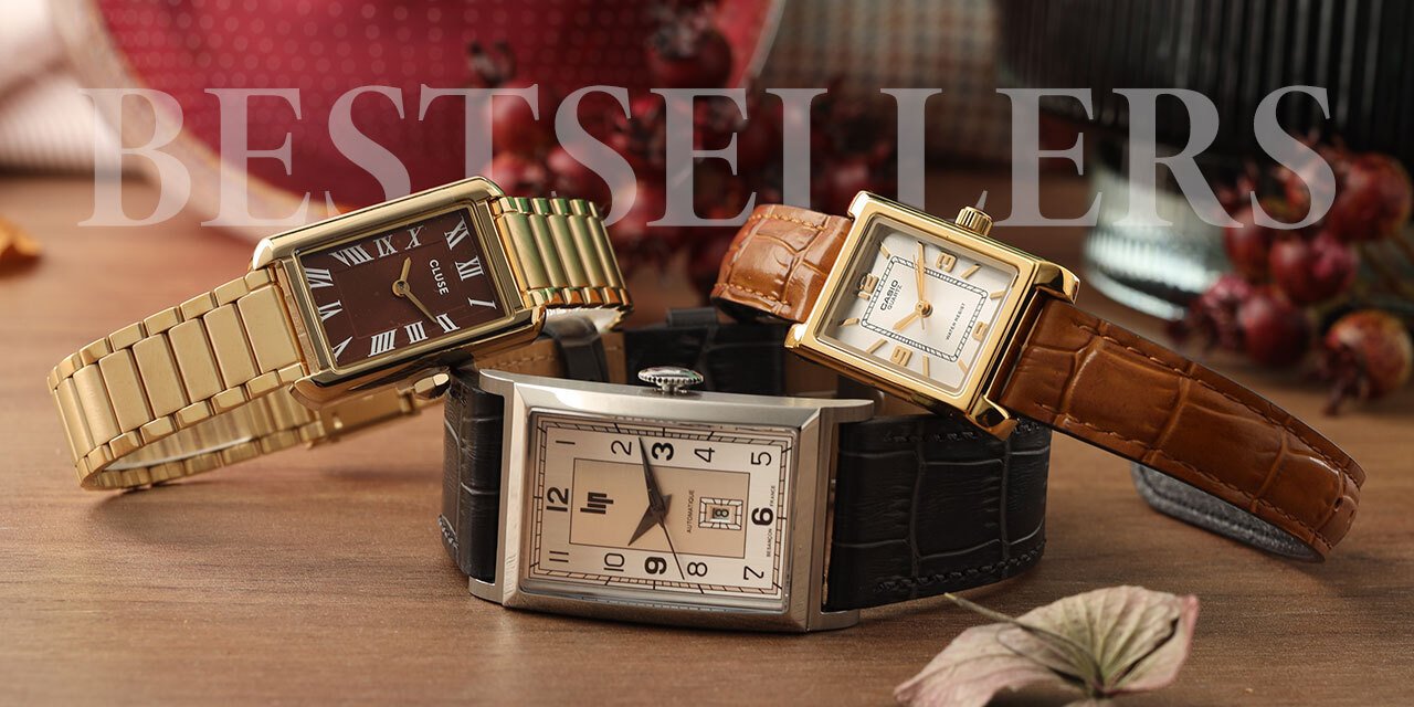 Three rectangular watches on a wooden table with the text 'Bestsellers'