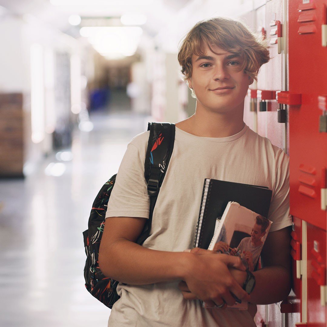 Teenage boy in school corridor