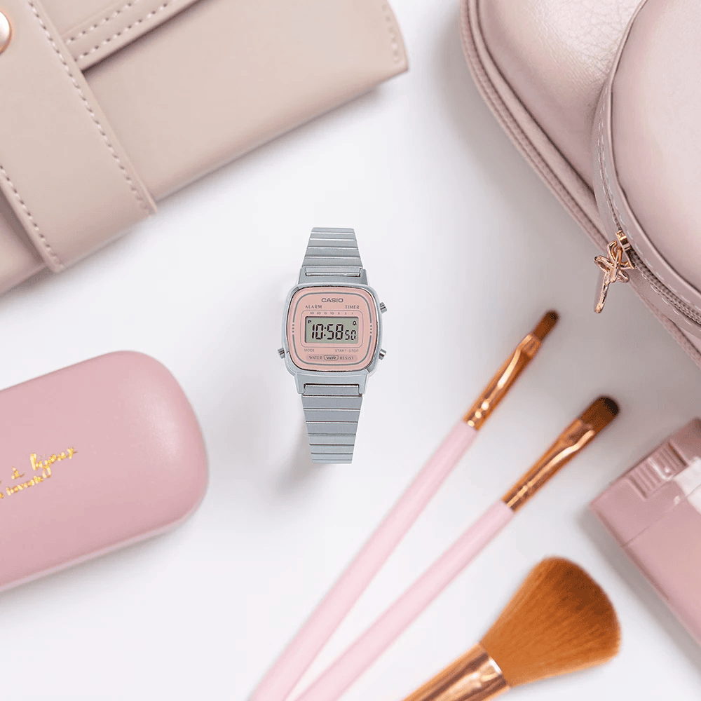 casio watch with a pink dial, surrounded by pink items from a ladies' purse