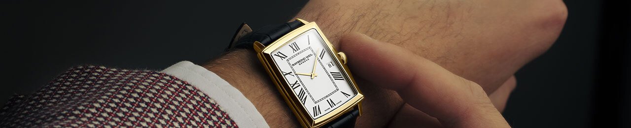man's wrist with a rectangular Raymond Weil watch