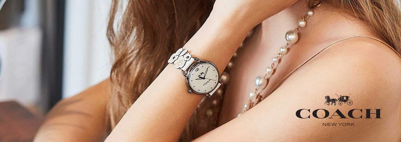 woman wearing a Coach watch and a pearl necklace