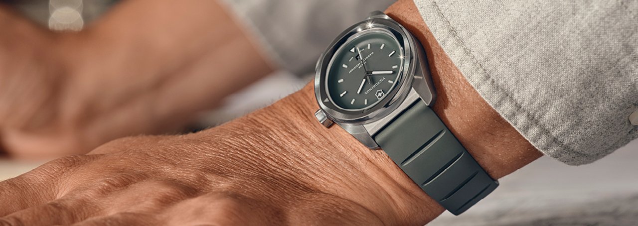 a man's wrist wearing a grey victorinox concept one watch