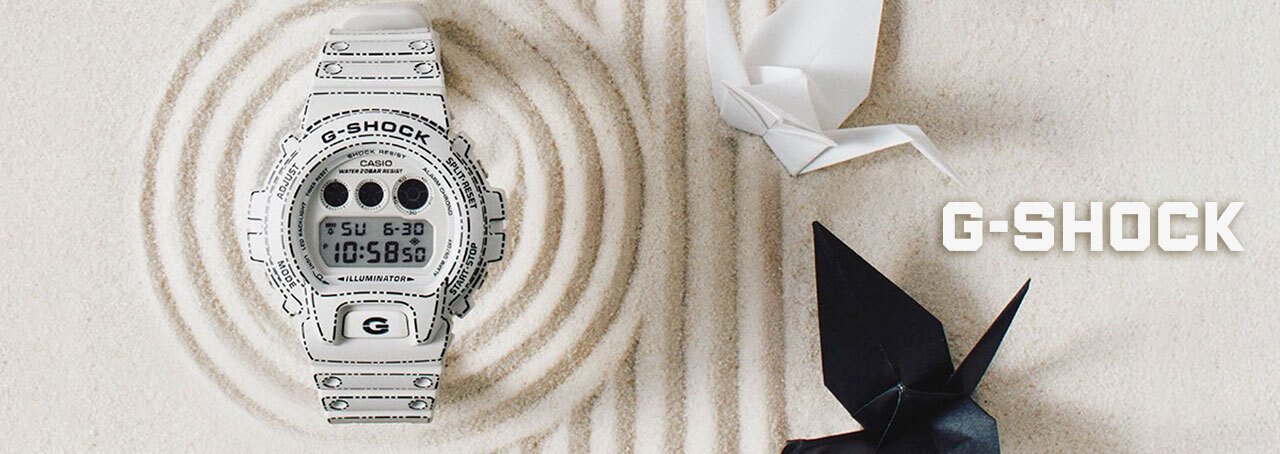 White g-shock on a sand background