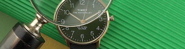 Nahaufnahme eines Vergrößerungsglases und einer Timex-Uhr