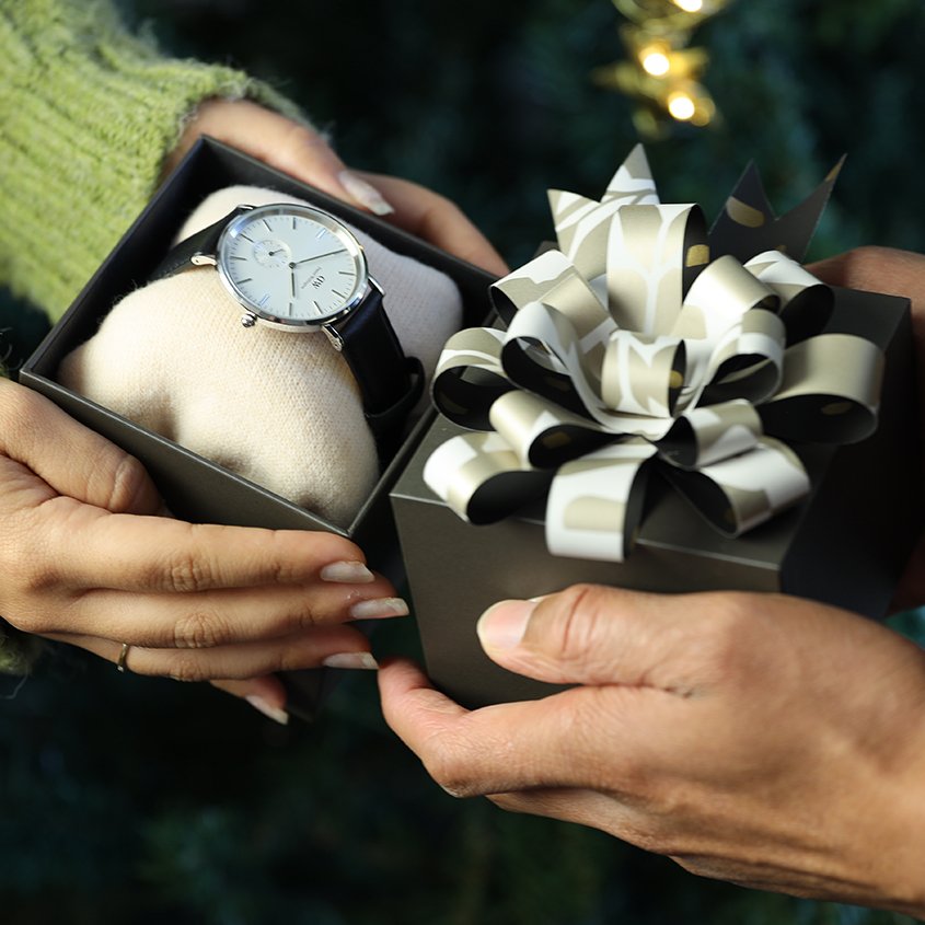 man and woman exchanging gift