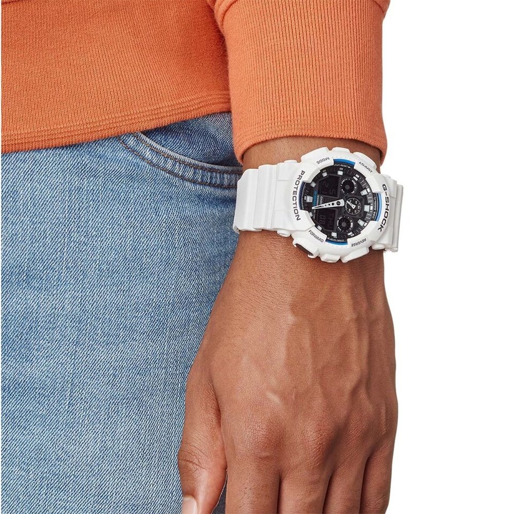 wrist of a man wearing a white g-shock watch