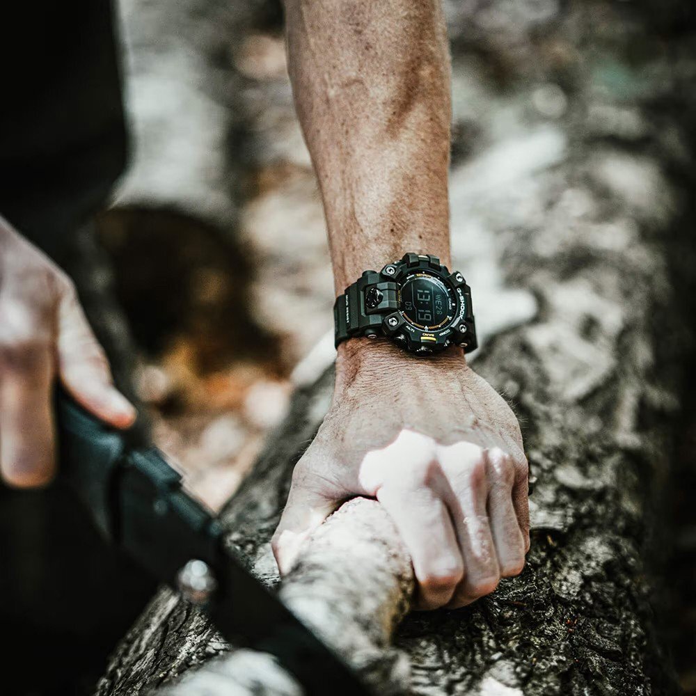 Man sawing a tree while wearing a G-shock watch