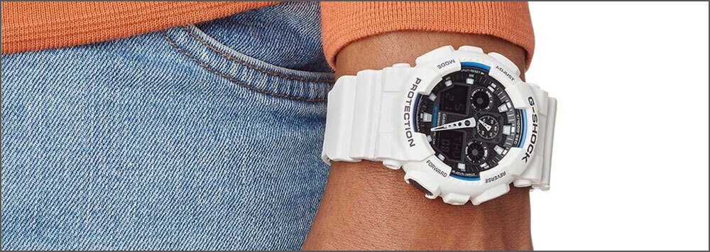 wrist of a man wearing a white g-shock watch