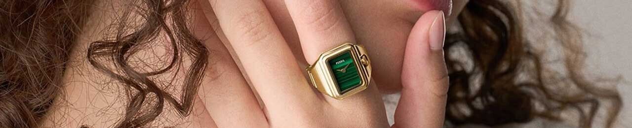 womans hand with a ring watch