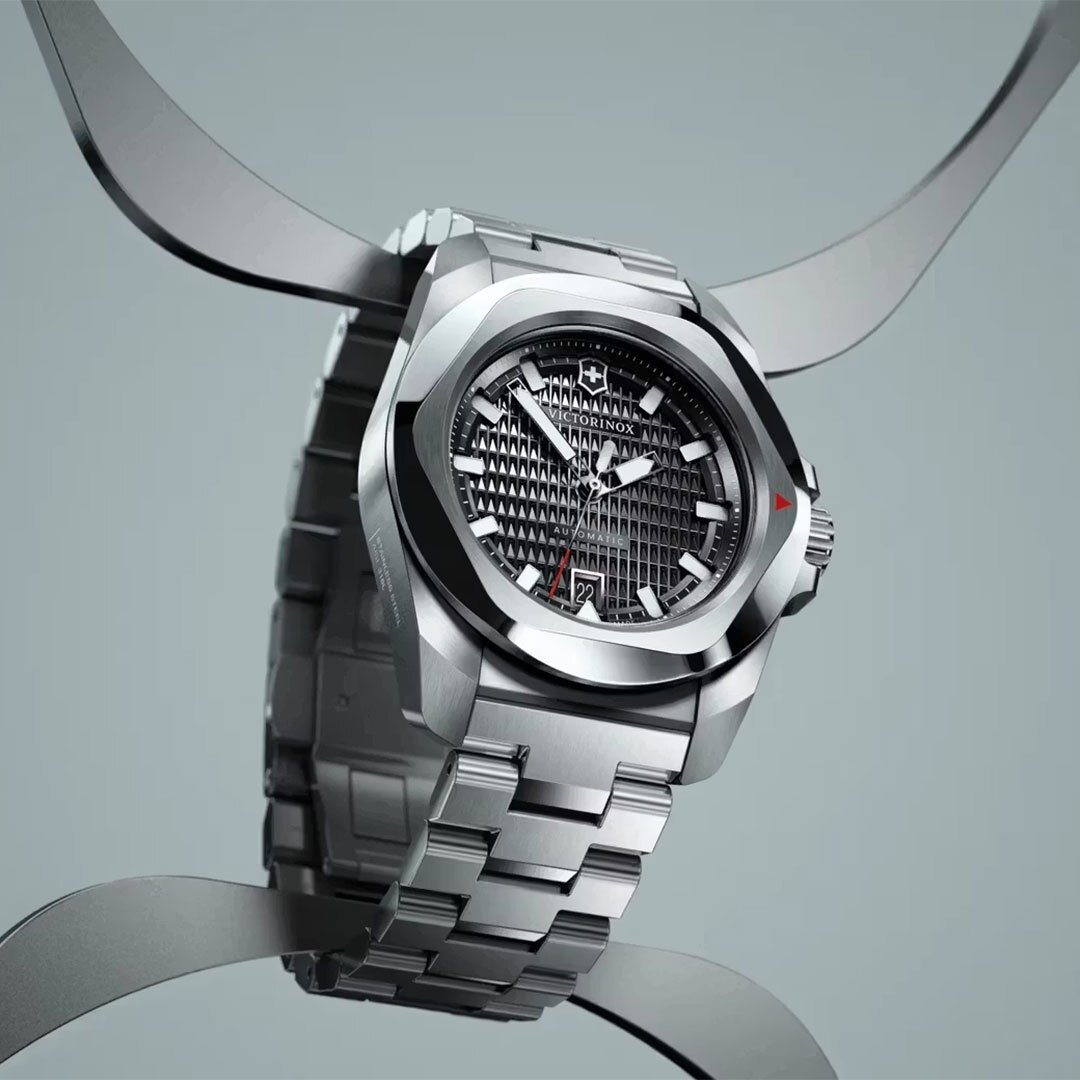 Stainless steel Victorinox INOX watch hanging from a steel hook