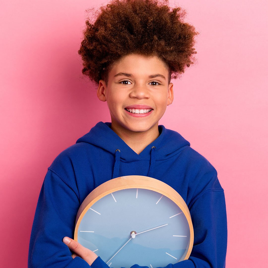 Boy holding a clock