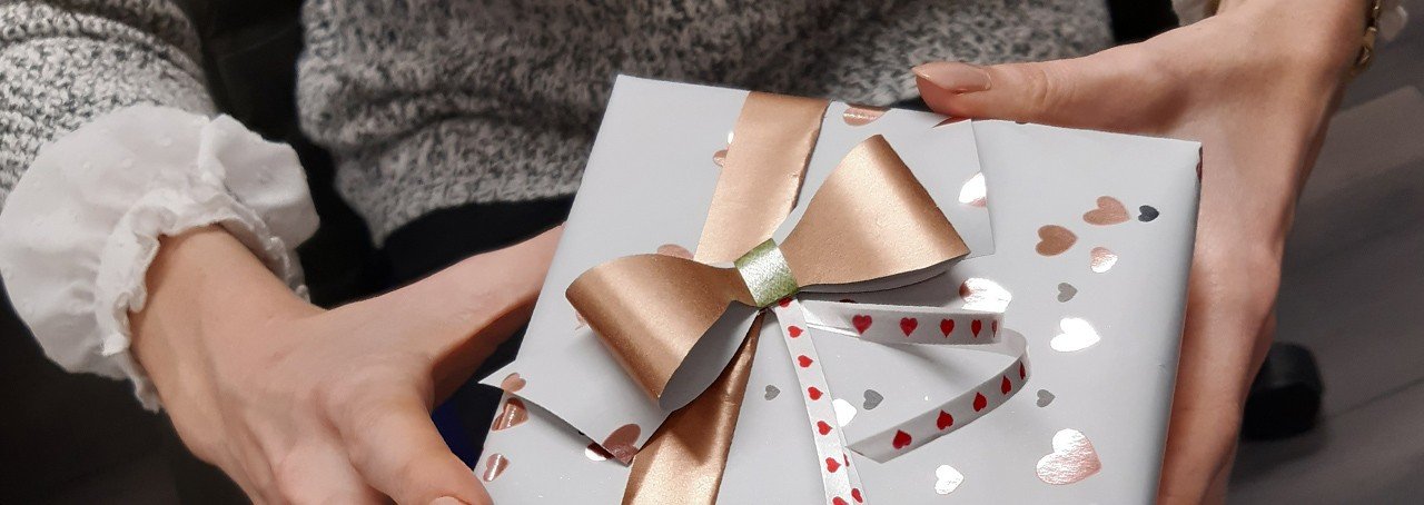 A woman's hands holding a Valentine's Day gift