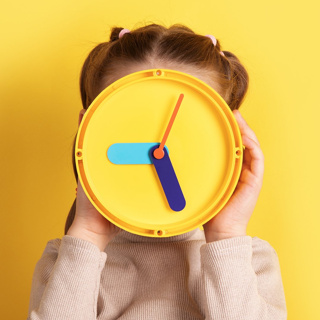 Little girl holding a clock