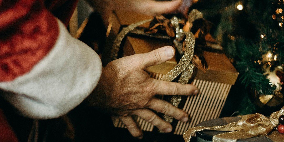 close up of santa's hands and a gift