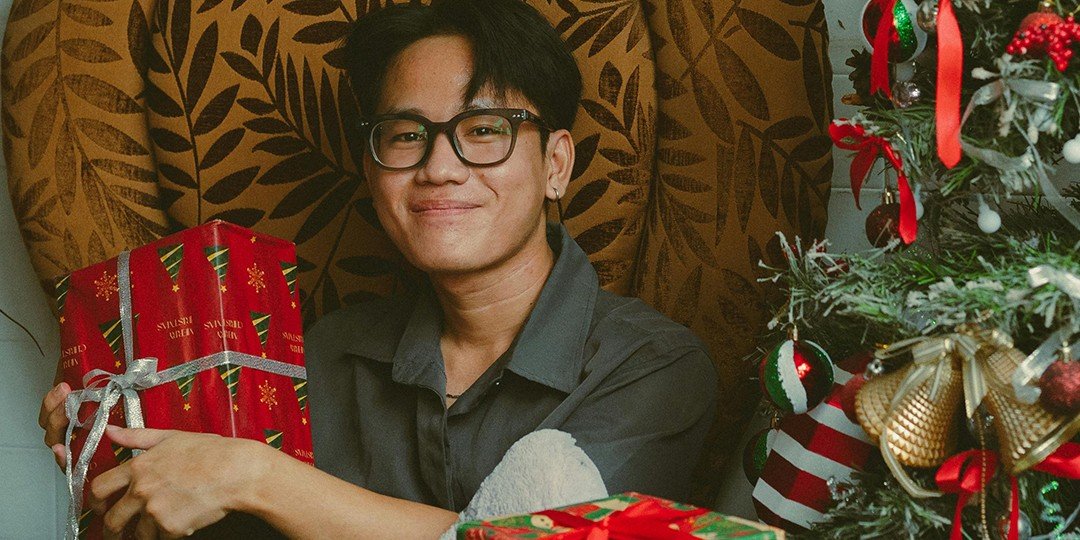 asian man holding a christmas gift