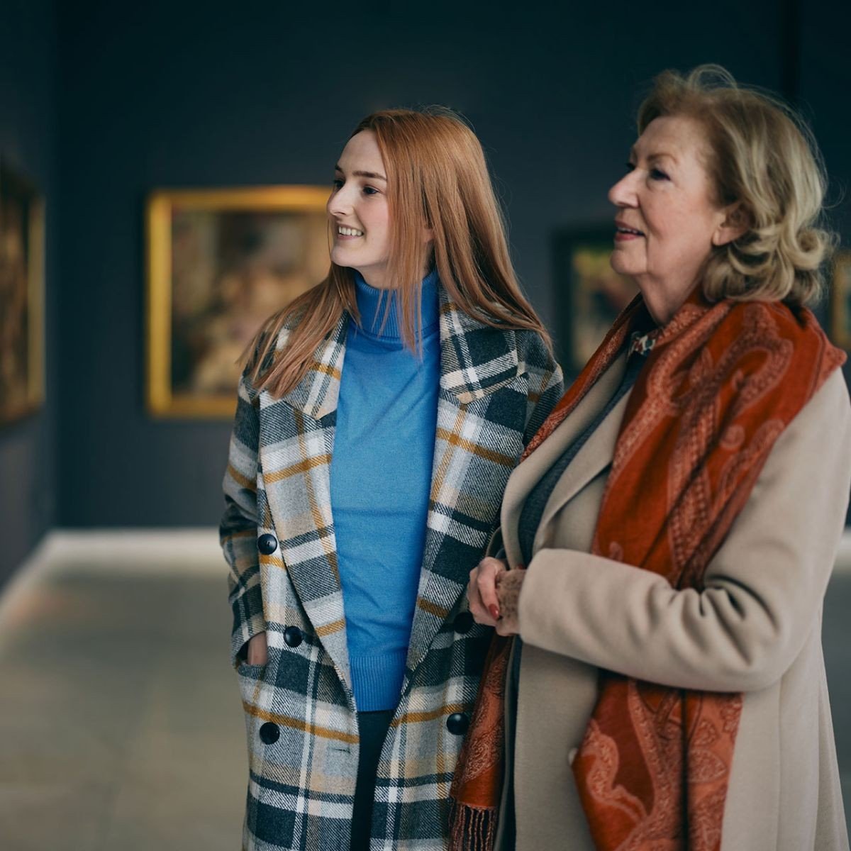 Mother and daughter looking at paintings