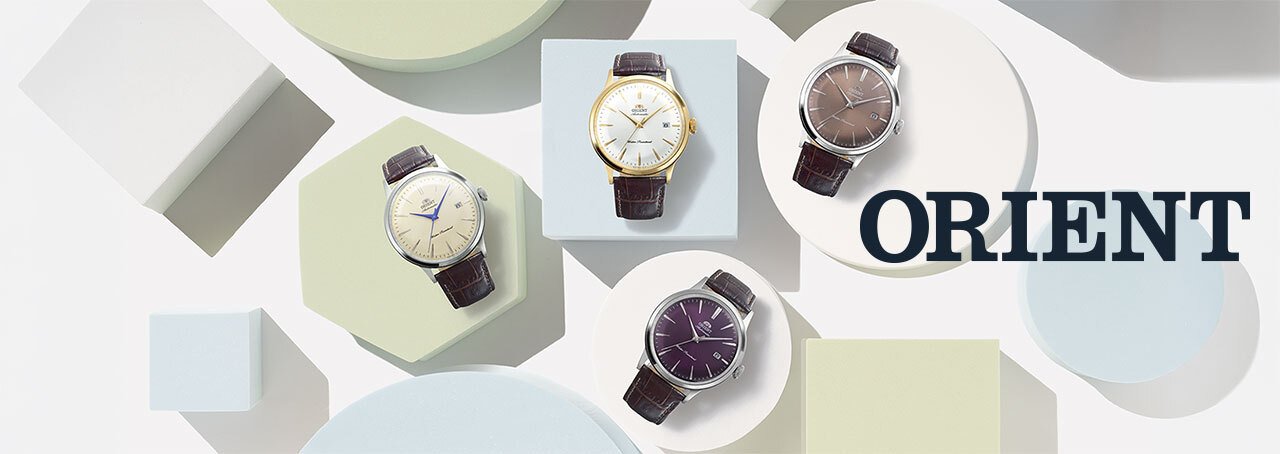 4 orient bambino watches on pastel colored blocks