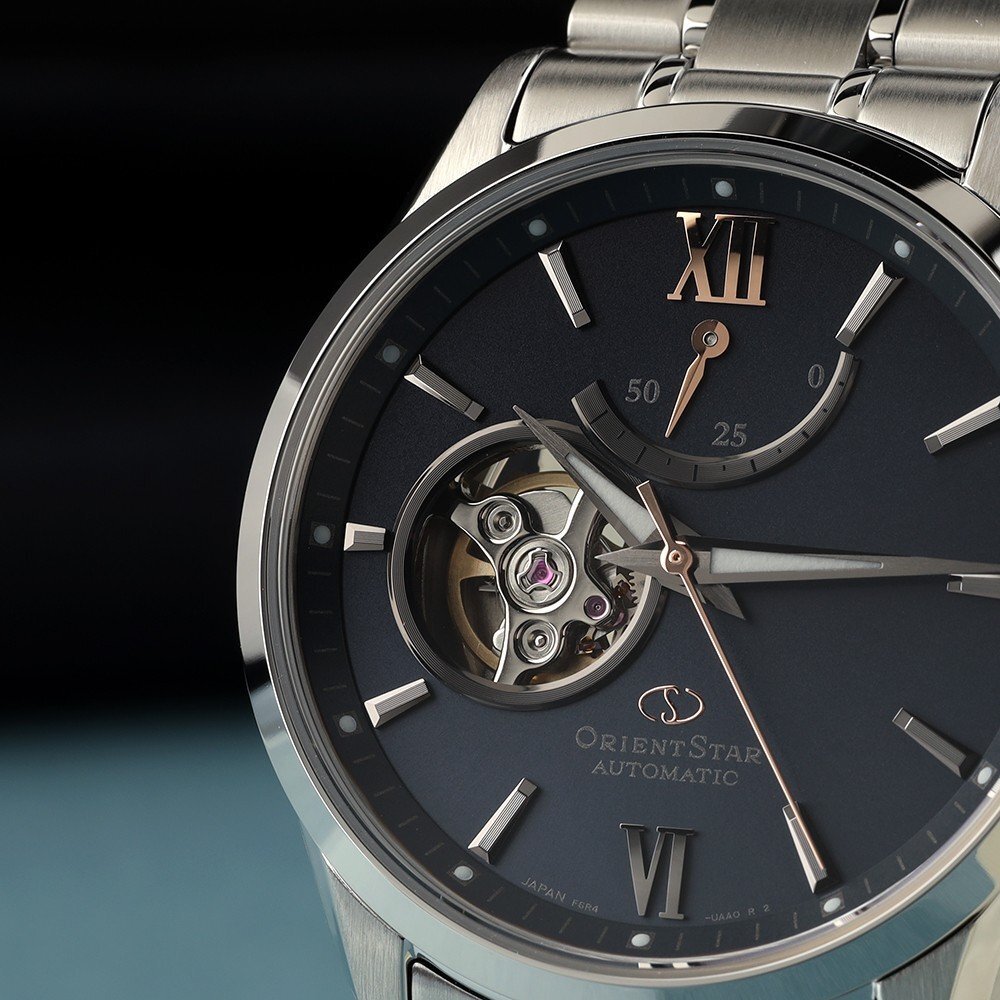Close up of Orient Star watch with power reserve indicator, small seconds, and open heart