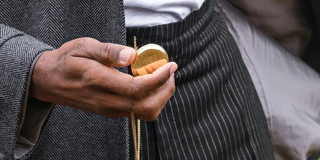 Man opening a gold pocket watch