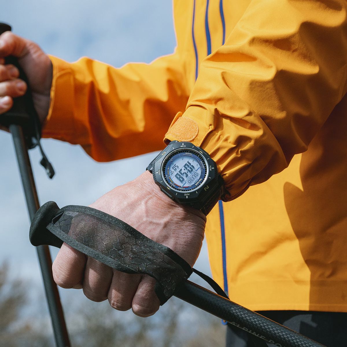Man holding Nordic walking sticks and wearing a PRG-69 watch