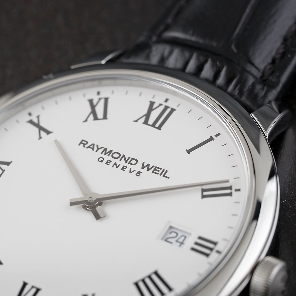 Close up of a Raymond Weil watch with roman numerals