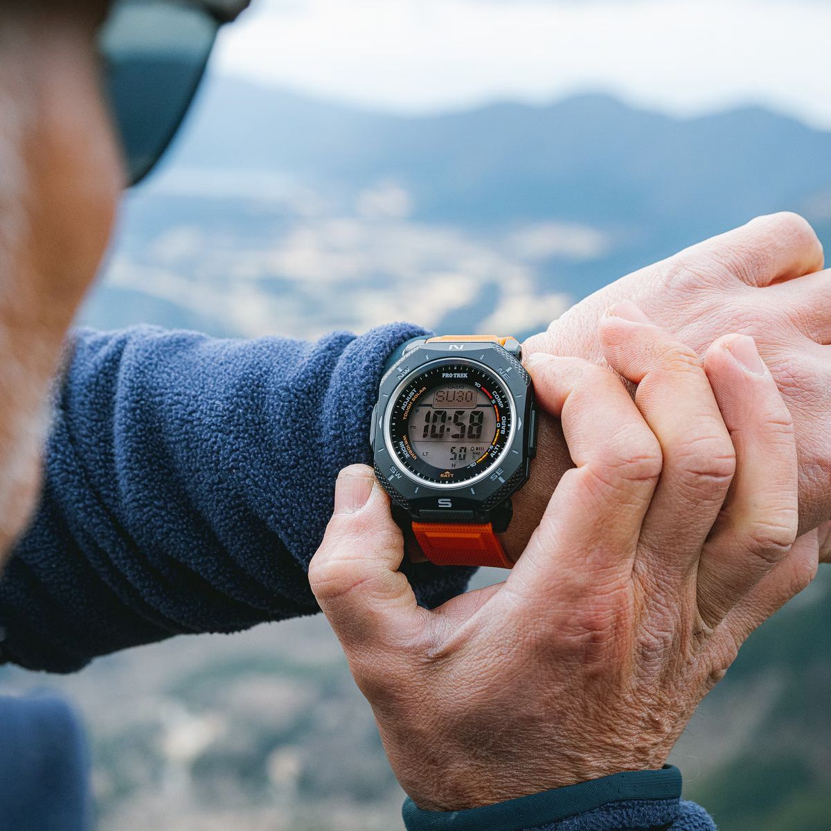 Man pressing button of his PRG-69 watch to illuminate the dial