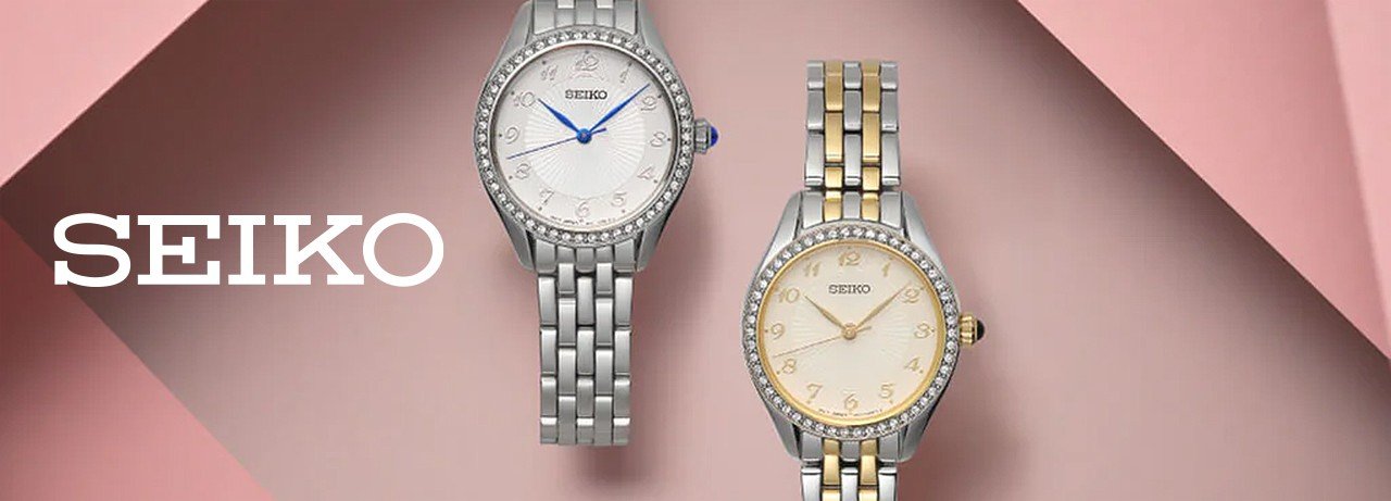 two seiko ladies watches on a pink background