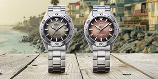 Four Orient Bambino watches on pastel colored blocks