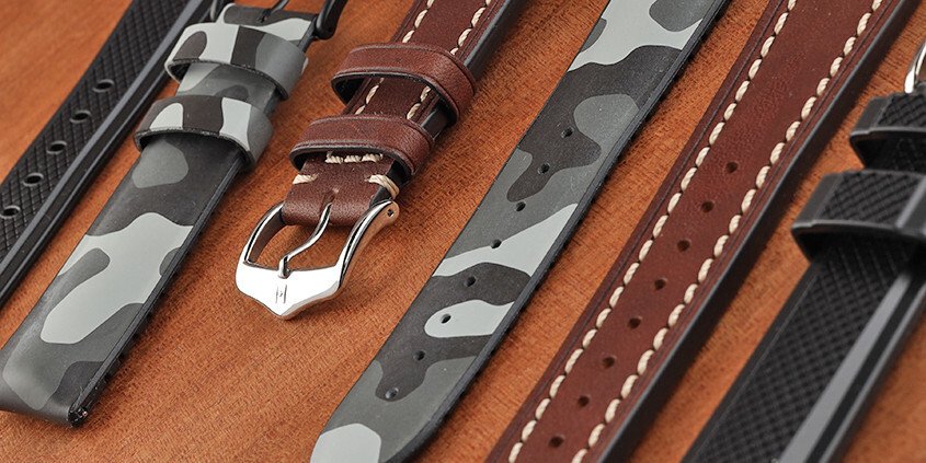 Close up of watch straps on a wooden table