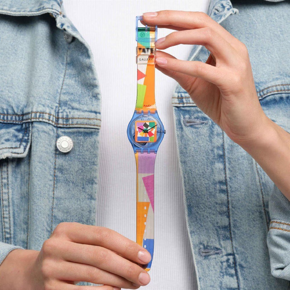 Woman holding a Swatch watch with a Matisse print