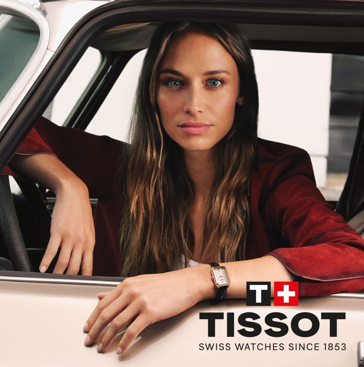 Woman sitting in car with Tissot logo