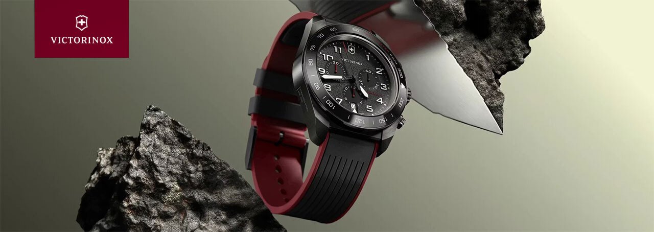 black victorinox watch between two pieces of rock