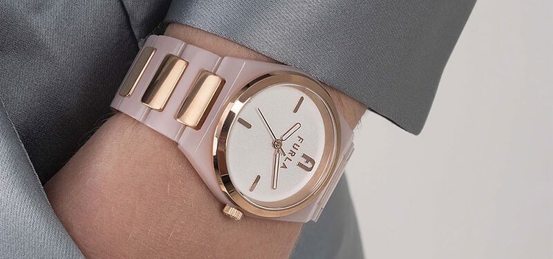 Woman's wrist with a pink Furla watch