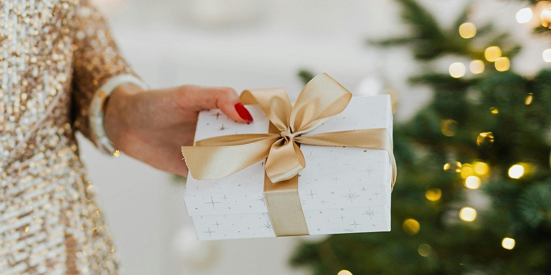 close up of woman's hands holding a christmas gift