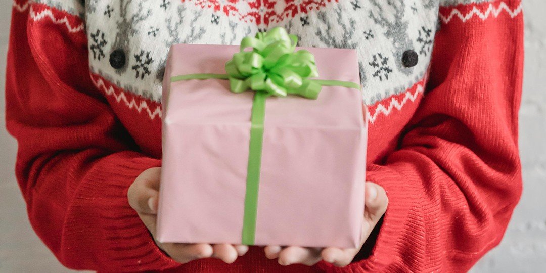 close up of woman's hands holding a christmas gift