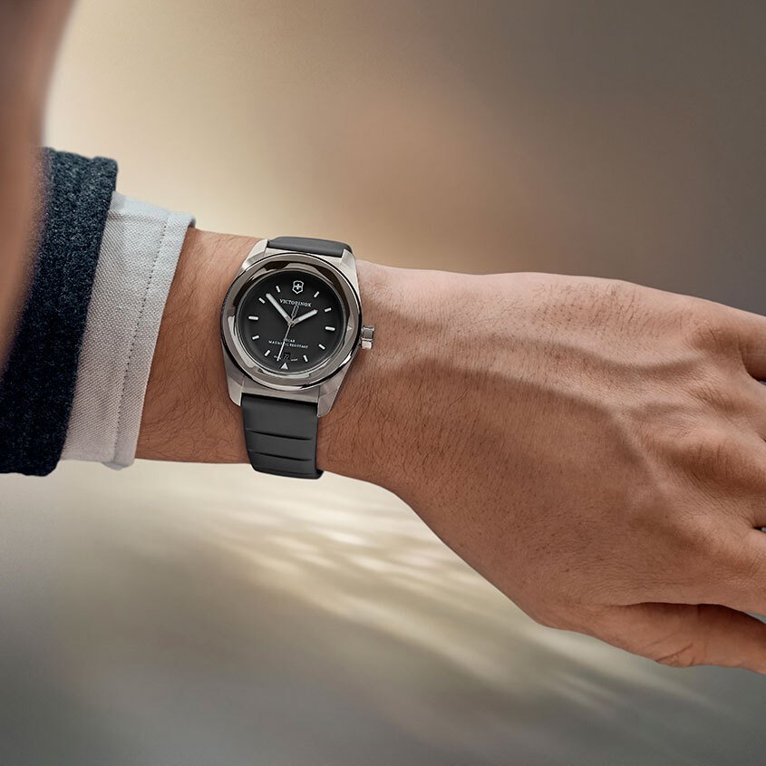 a man's wrist wearing a grey victorinox concept one watch